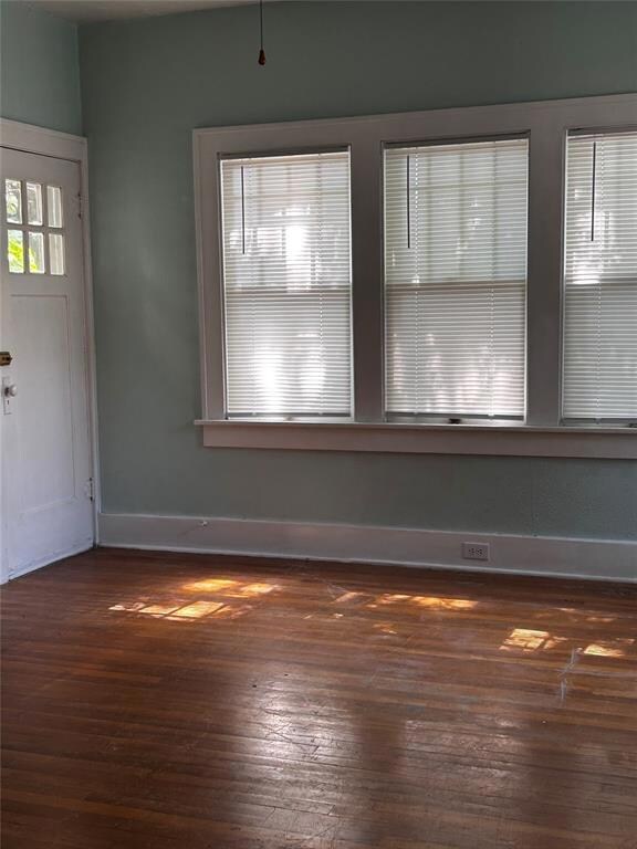 Unfurnished room featuring hardwood / wood-style f
