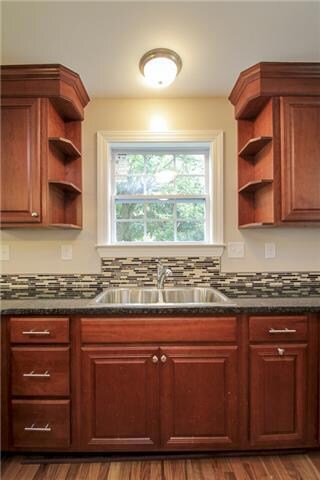 Enjoy your view from your bright window! Beautiful tile, stainless steel sinks with disposal make doing dishes 