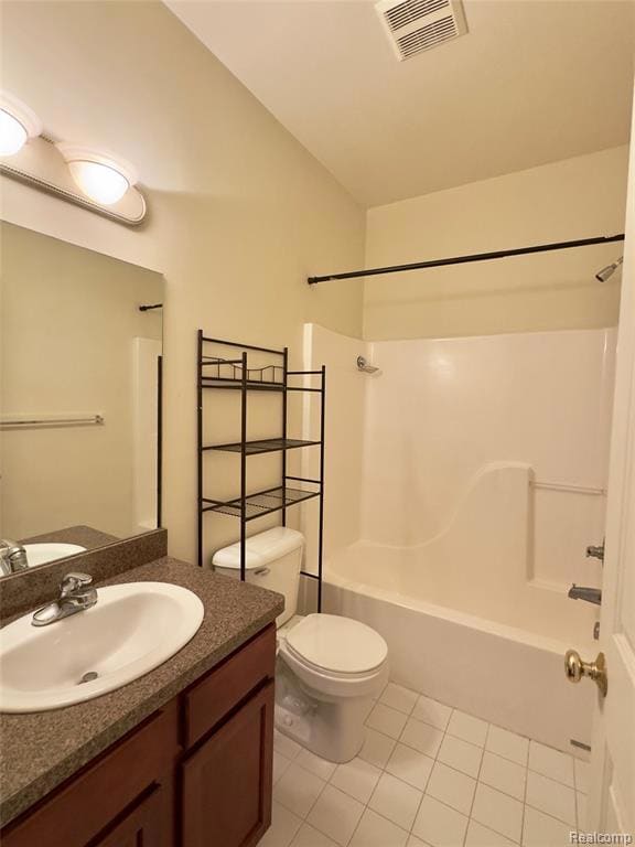 Bathroom with bathtub / shower combination, light tile patterned floors, and vanity
