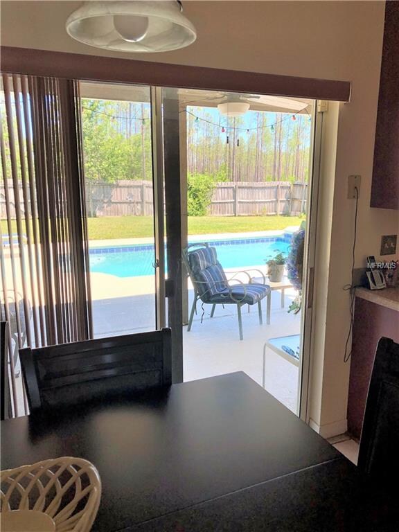Dinette overlooking the large fenced-in back yard 