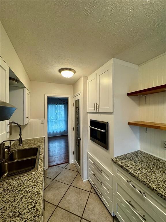 Tons of cabinets and a pantry. Door leads to the d