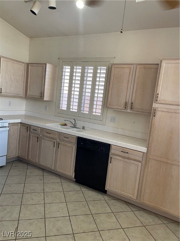 Kitchen featuring tile counters, range, dishwashin