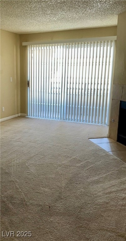 Carpeted empty room featuring a textured ceiling a