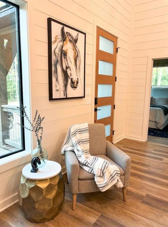 Living area with hardwood / wood-style floors and 