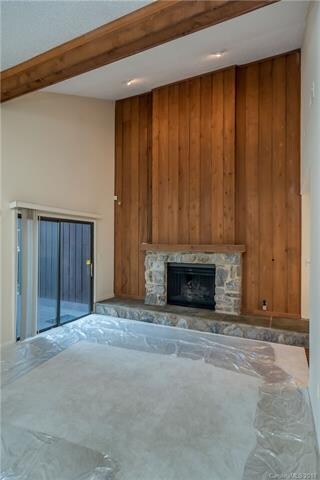 Vaulted ceiling in living room and gas fireplace. 