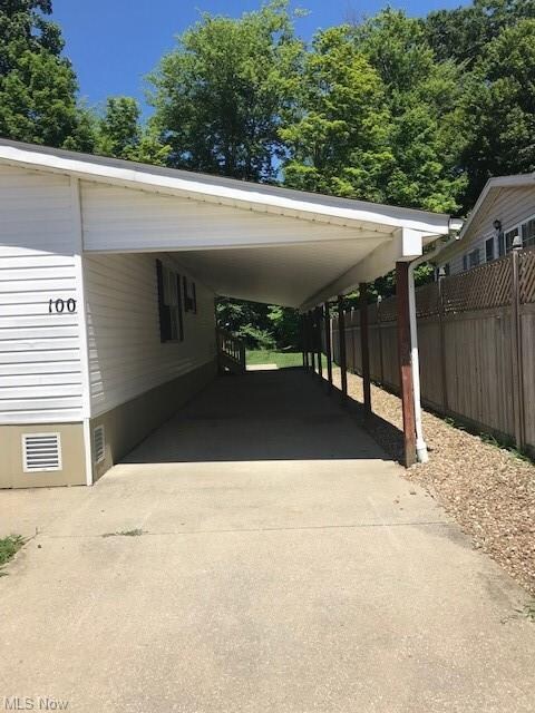 Long two car carport with a privacy fence.
