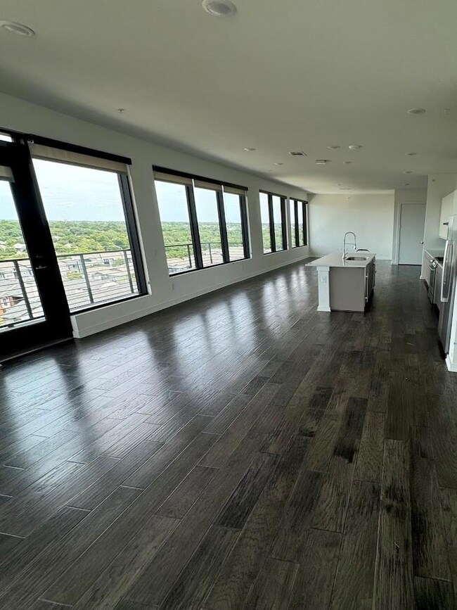 Empty room featuring sink and dark hardwood / wood