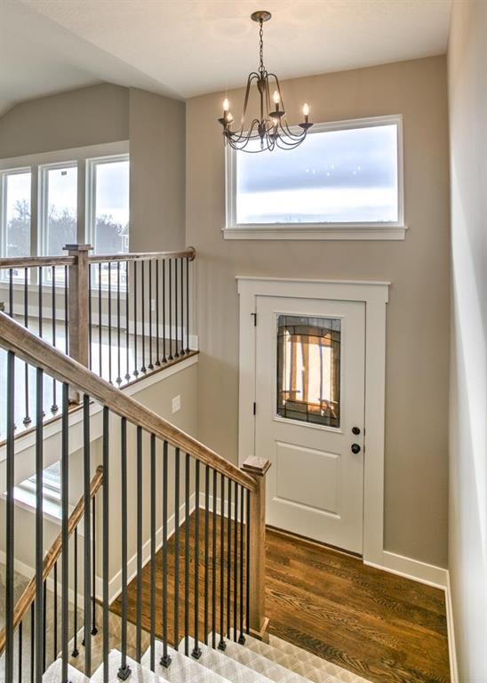 Entry way with hardwood floor and metal chandelier