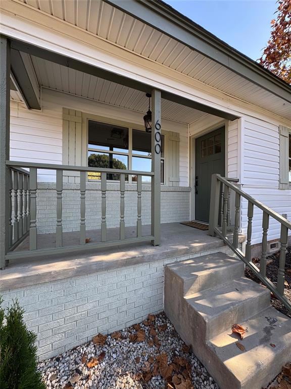 View of exterior entry with a porch