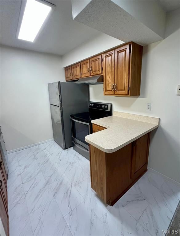 Kitchen with brown cabinets, light marble finish floors, stainless steel appliances, a peninsula, and light countertops