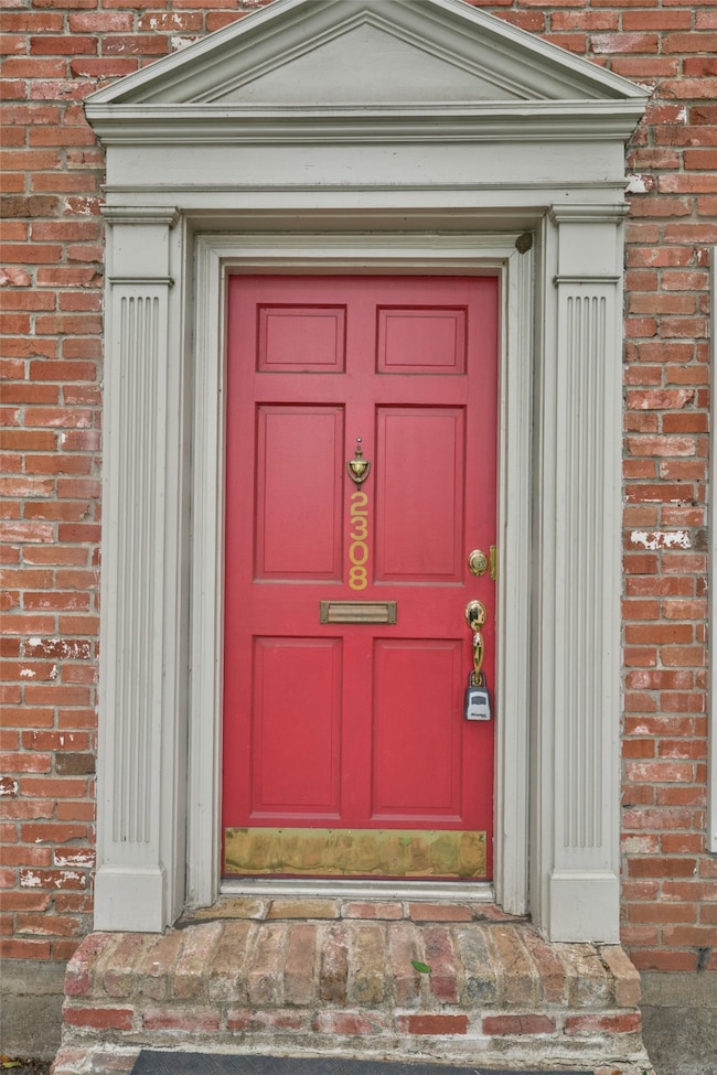Charming red door set in a classic brick facade, a