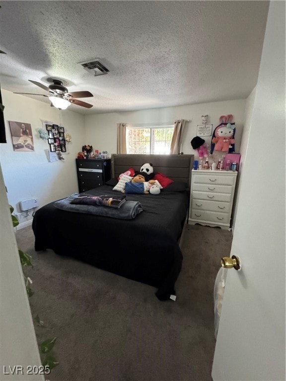 Carpeted bedroom with a textured ceiling and a cei