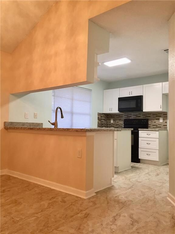 Kitchen displaying all brand new stylish cabinets