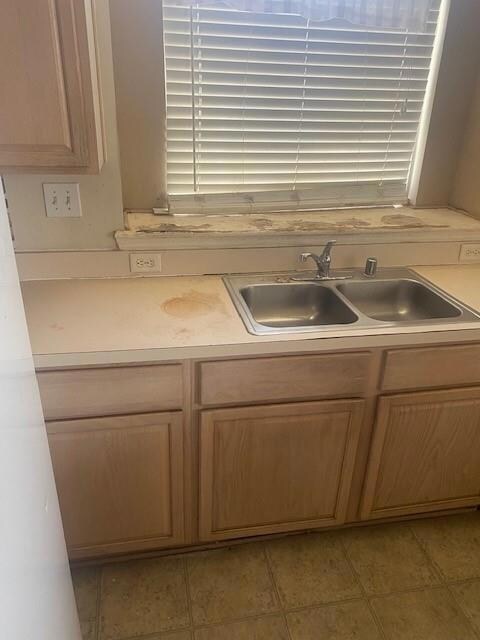 Kitchen with sink and light tile patterned flooring