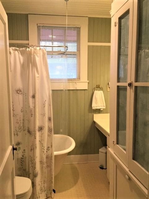 Guest bath has clawfoot tub and period finishes.
