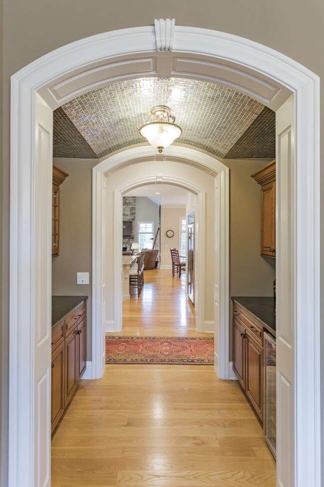 Lovely arched openings with rich molding are found throughout.
