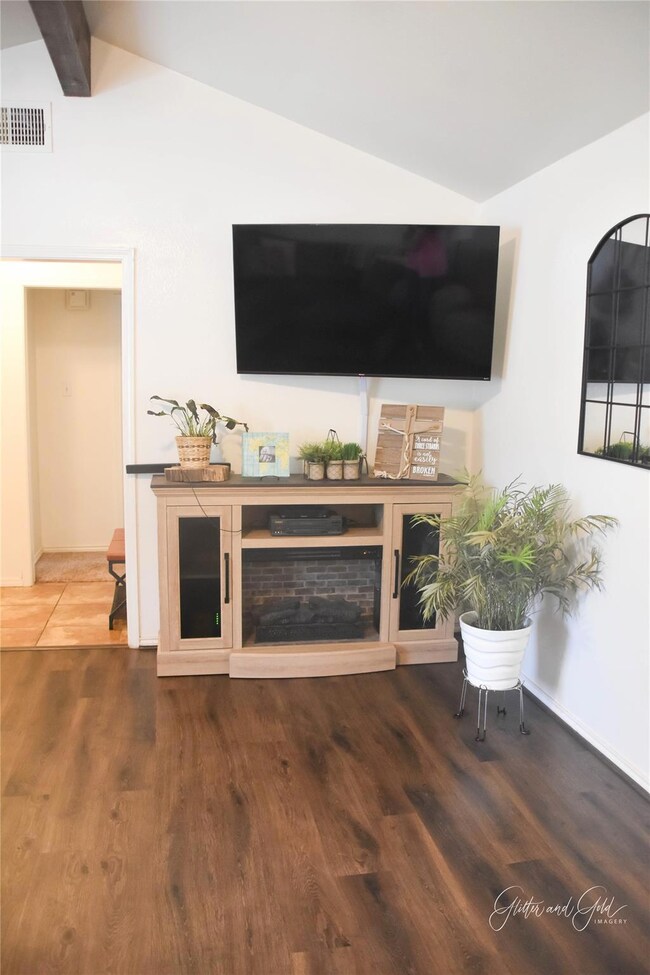 Unfurnished living room featuring wood finished fl