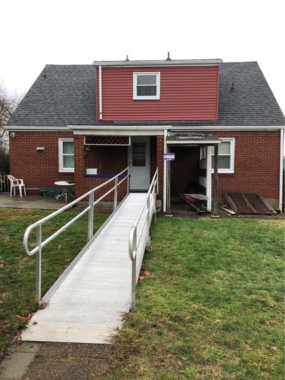 Rear view of home and yard. Ramp will be removed