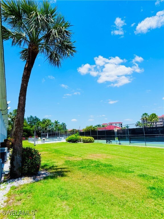 View of yard featuring a tennis court