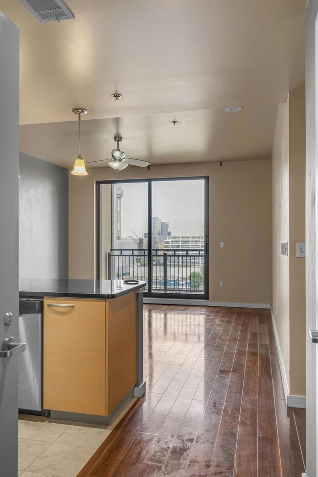 Kitchen with dark countertops, ceiling fan, decora