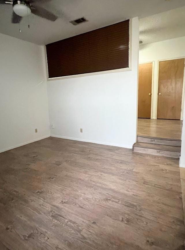 Unfurnished room featuring a ceiling fan, visible