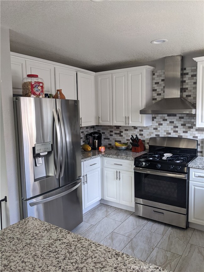 Remodeled kitchen, new cabinets counter tops, stove and hood 2020.