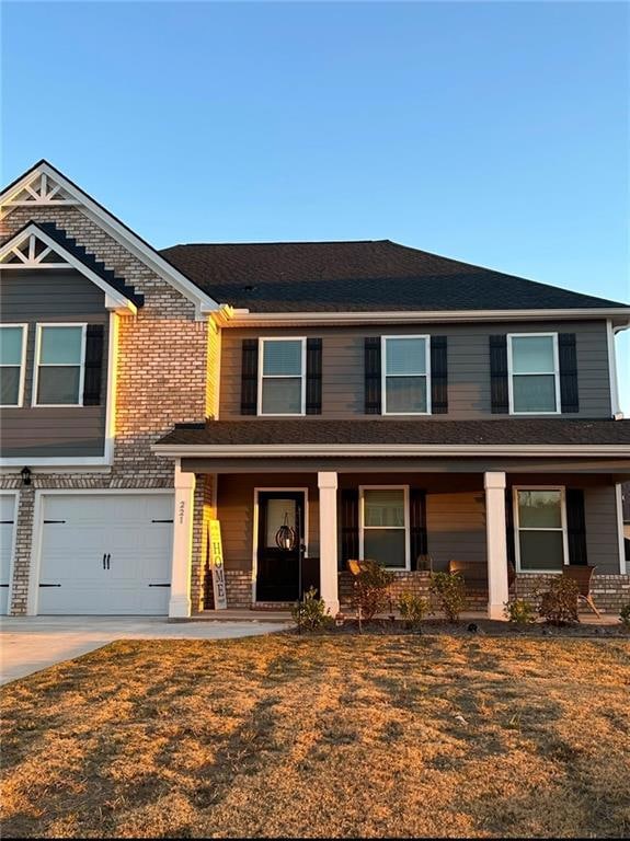 View of front facade with a garage, a porch, and a
