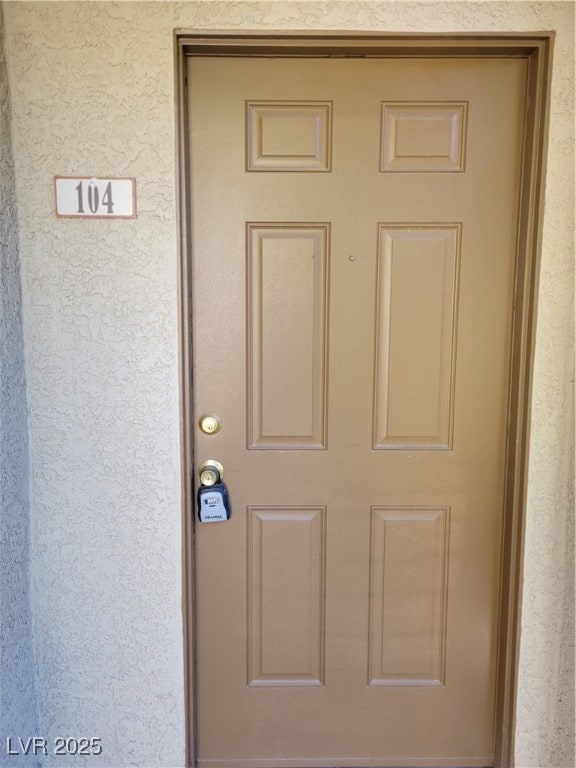 Entrance to property featuring stucco siding