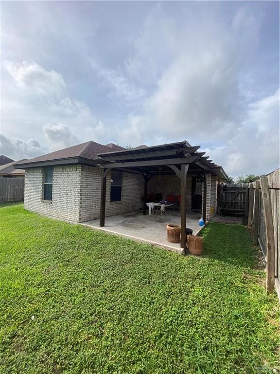Back of property with a pergola, brick siding, and a patio