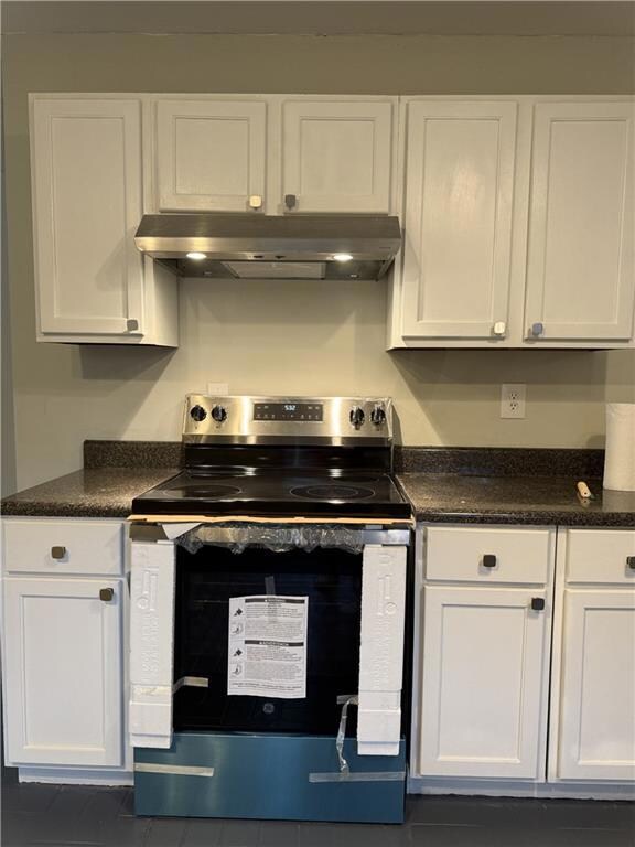Kitchen with stainless steel range with electric s