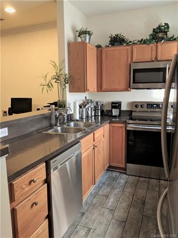 Kitchen boasts updated tile floor and all new Stai