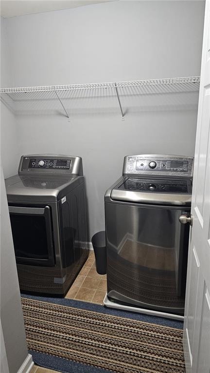 Laundry room featuring separate washer and dryer and light tile patterned flooring
