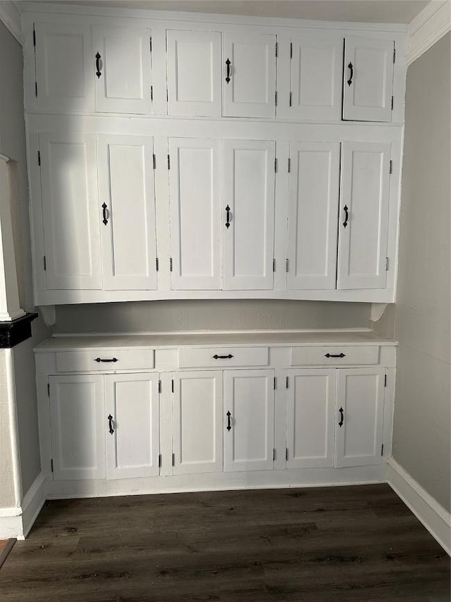 Detailed view of baseboards and wood finished floors