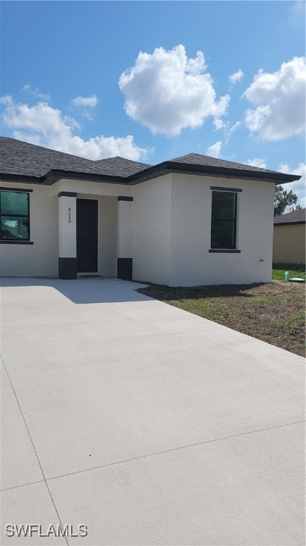 View of front of home featuring stucco siding