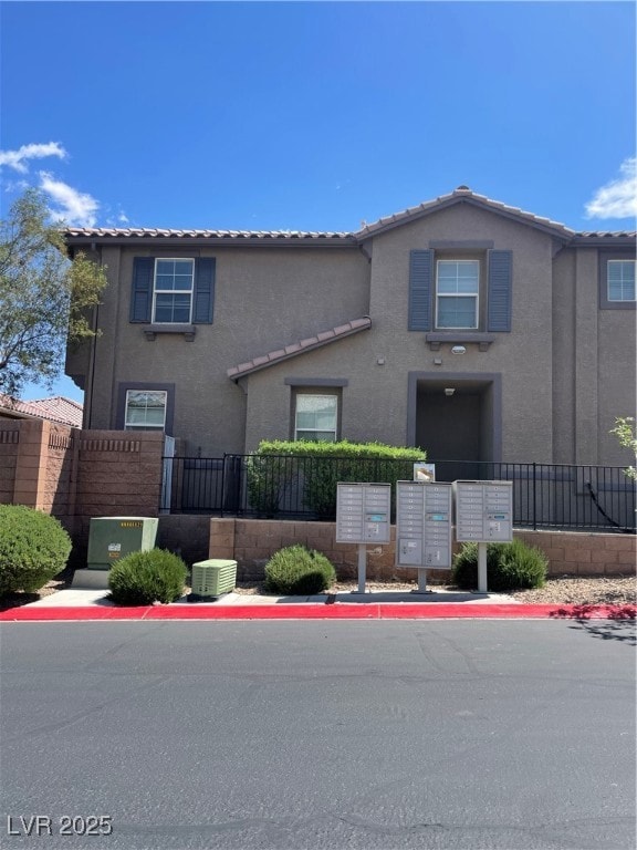 View of front of home featuring stucco siding, fen