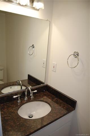 Main floor 1/2 bath with granite vanity top