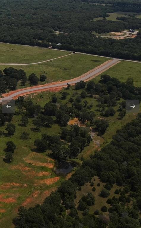 View of rural area with a heavily wooded area and property parcel outlined