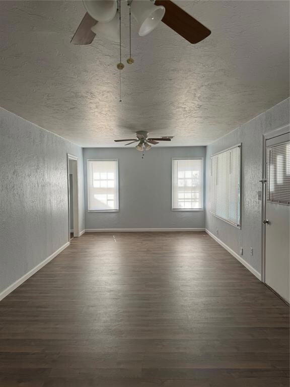 Unfurnished living room with dark hardwood / wood-