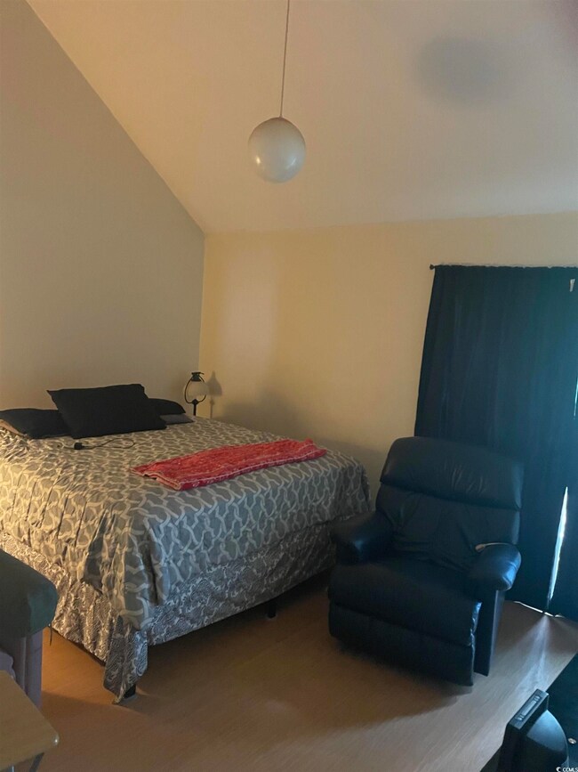 Bedroom featuring vaulted ceiling