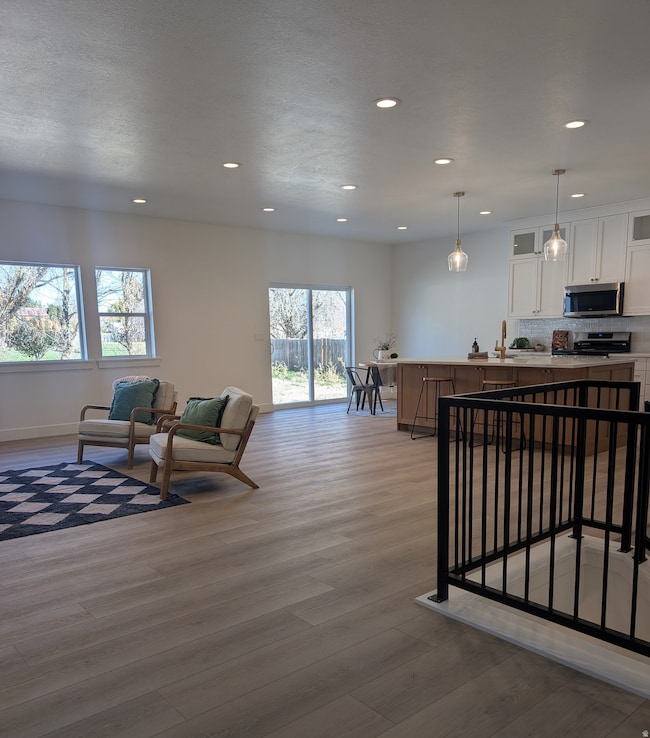 Living room featuring recessed lighting and light wood-type flooring