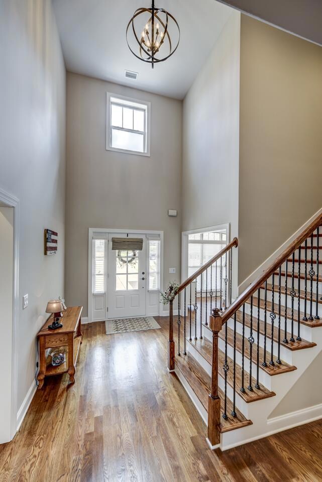 Hardwood staircase flanked with rod-iron spindles leads to second floor, which has 2 bedrooms, a full bath, bonus room, flex room and stand-up attic storage space.