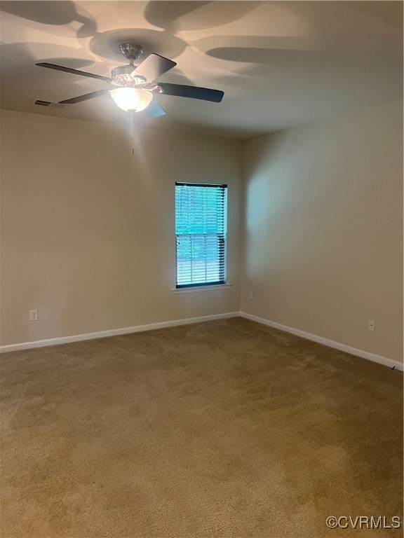 Unfurnished room featuring carpet floors, ceiling fan, and baseboards