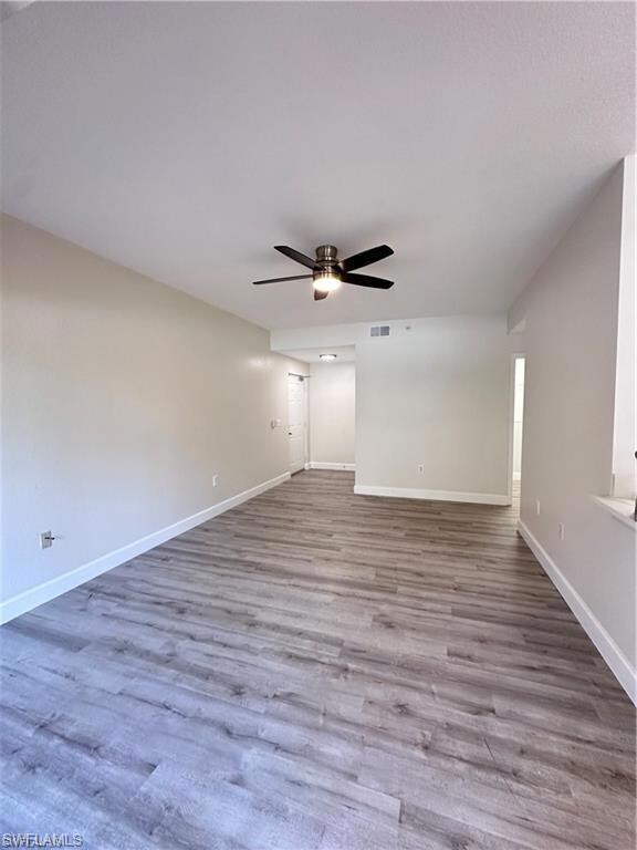 Empty room featuring wood finished floors, baseboa