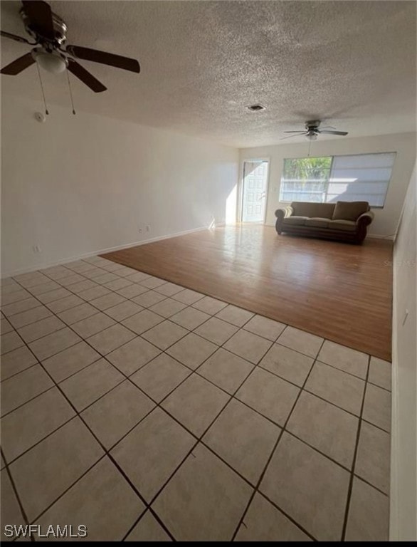 Unfurnished room featuring a ceiling fan, light ti