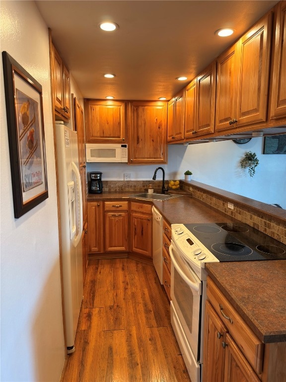 Kitchen with dark countertops, brown cabinets, a s