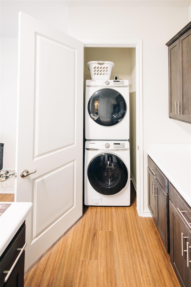 Washroom featuring stacked washing machine and dr