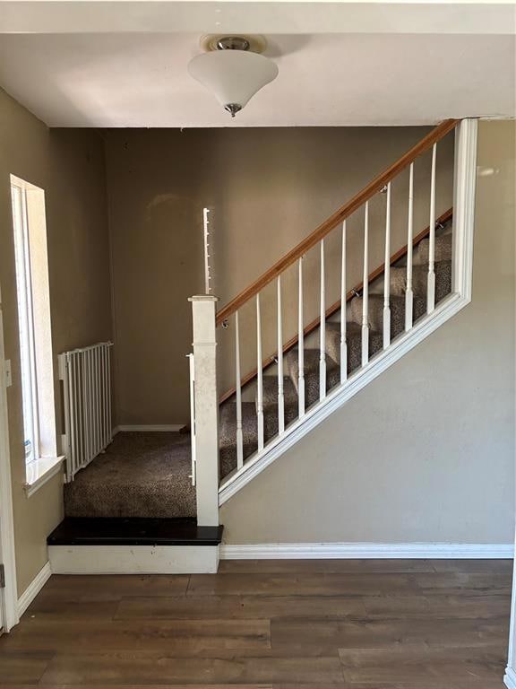Stairs with baseboards and wood finished floors