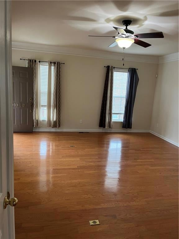 Living room with baseboards, crown molding, wood f