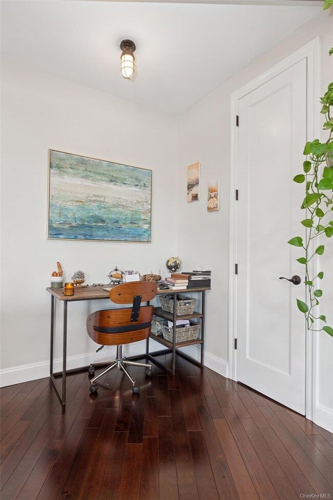 Office area with dark wood-style flooring
