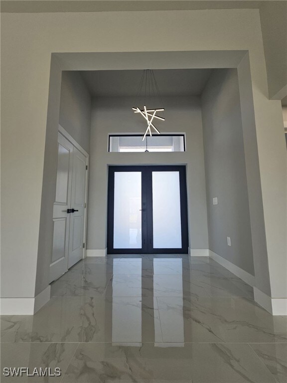 Entrance foyer with a high ceiling and french door